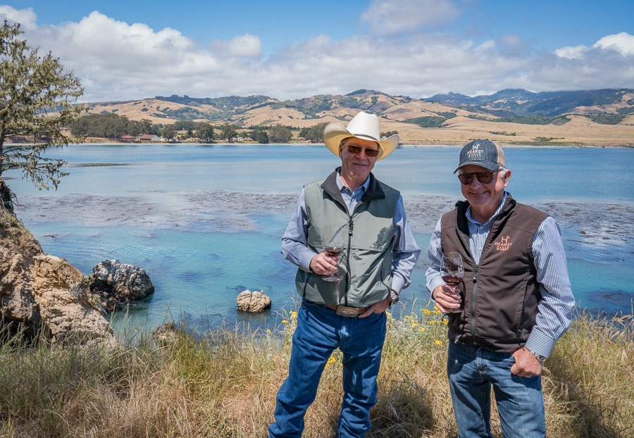 Steve Hearst, left, and Jim Saunders, right, co-owners and founders of Hearst Ranch Winery at San Simeon Pint with Hearst Castle in the background.