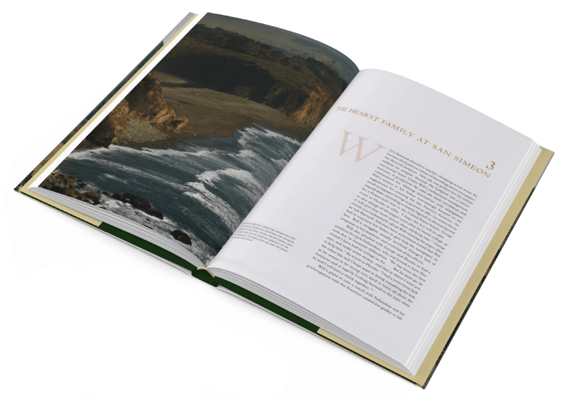The Hearst Ranch: Family, Land and Legacy book lies open, showing a full-page picture of the coast and some text.