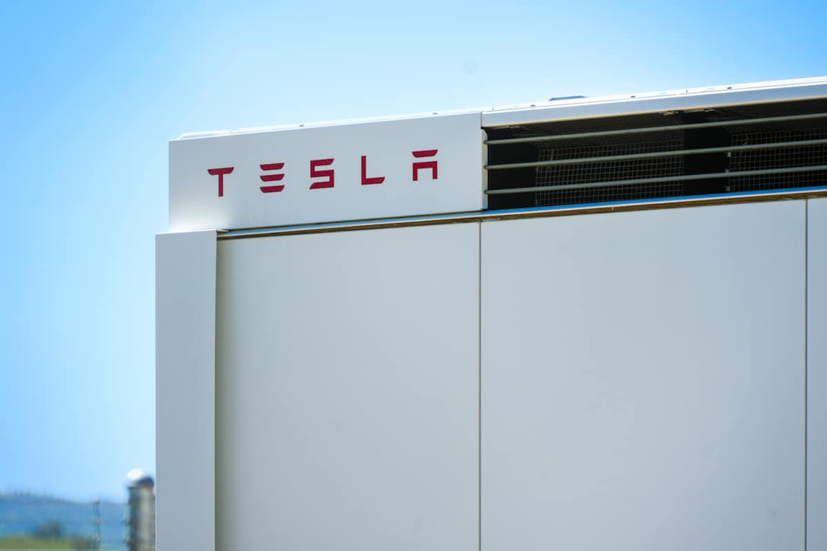 A close up shot of the Tesla logo on the Tesla Megapack.