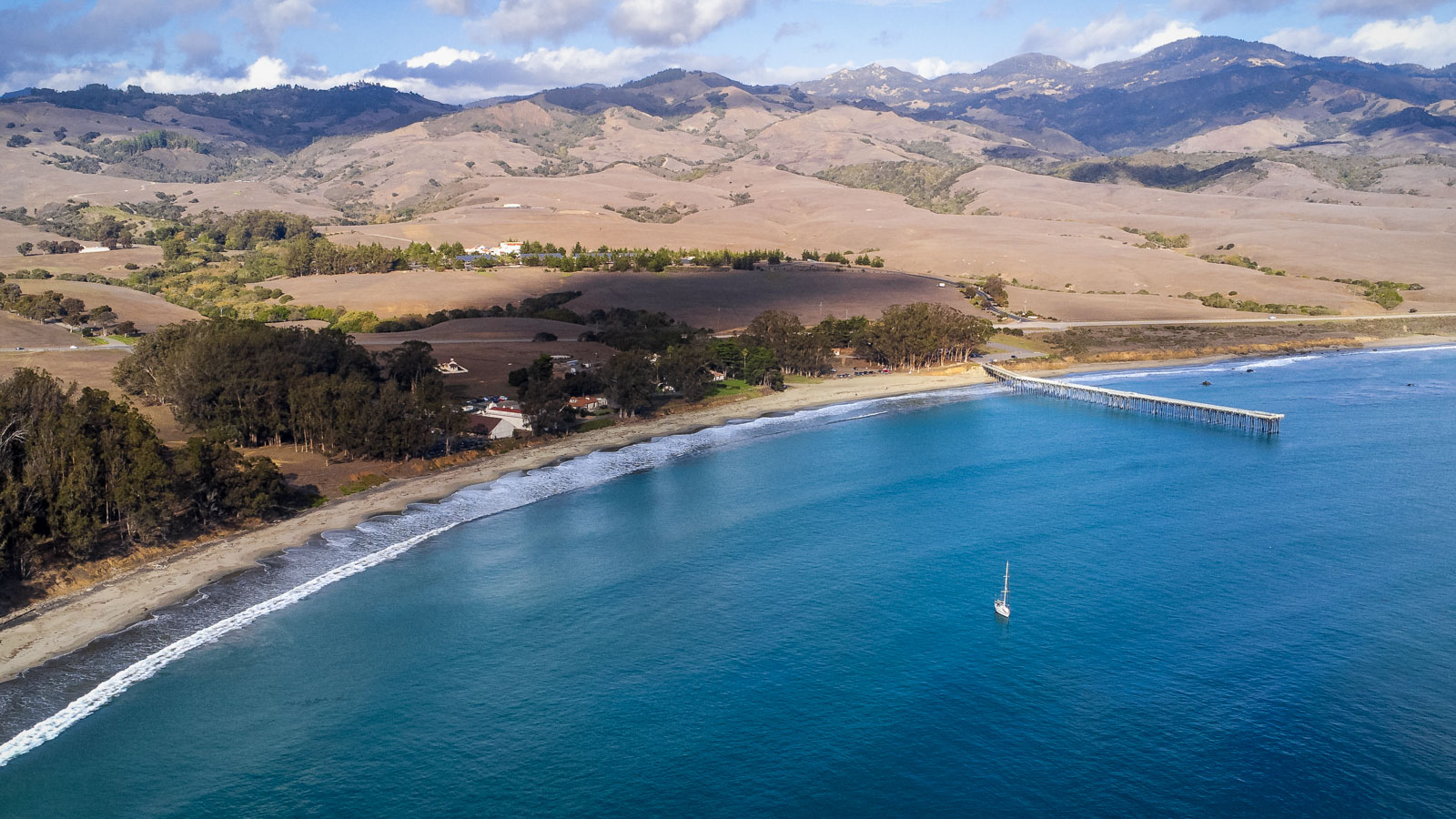 An aerial view of Hearst Ranch, with San Simeon Pier and the ocean visible.